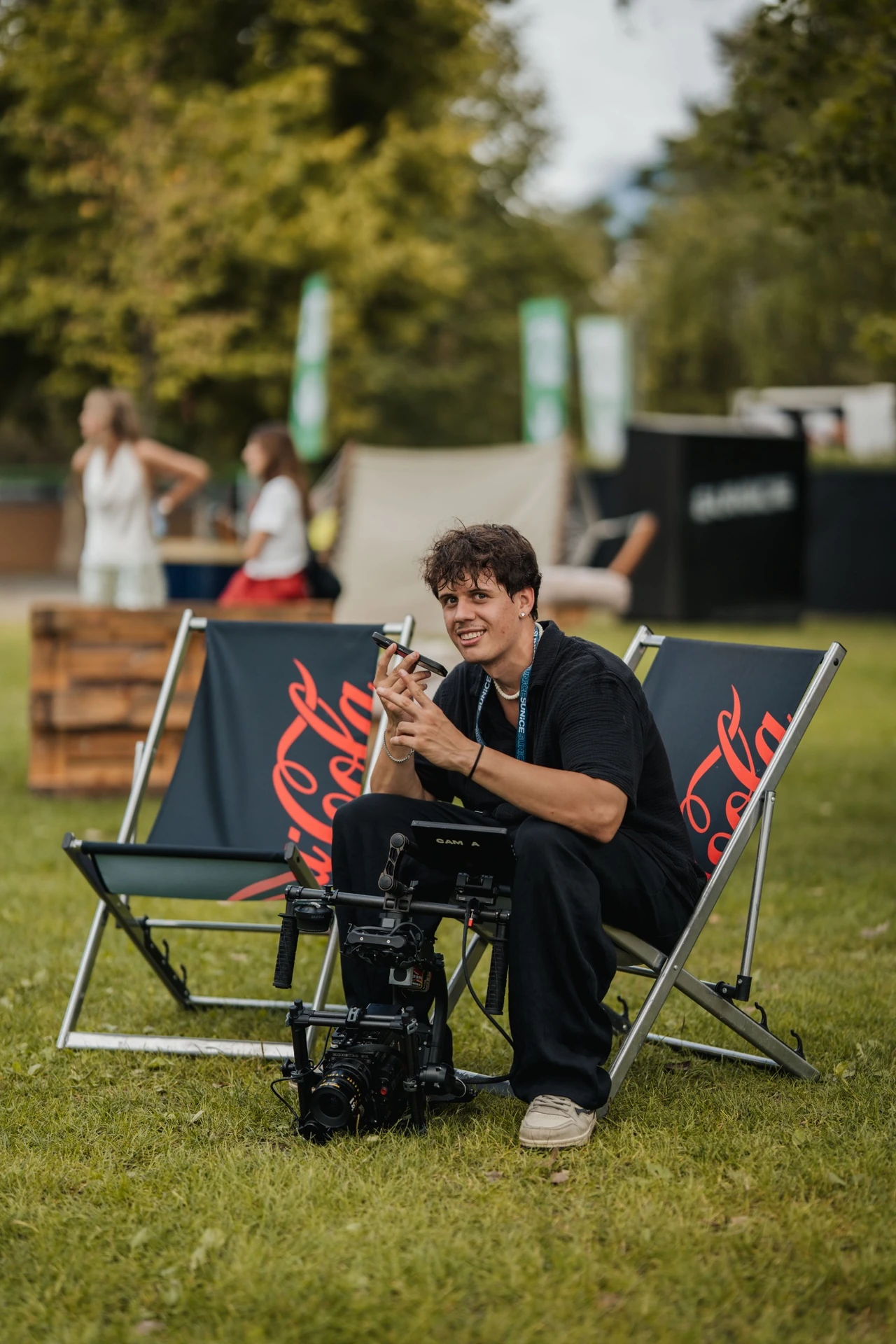 Kieran Steiner sitting in a deck chair at SunIce Ascona, with his cinema camera in front of him.